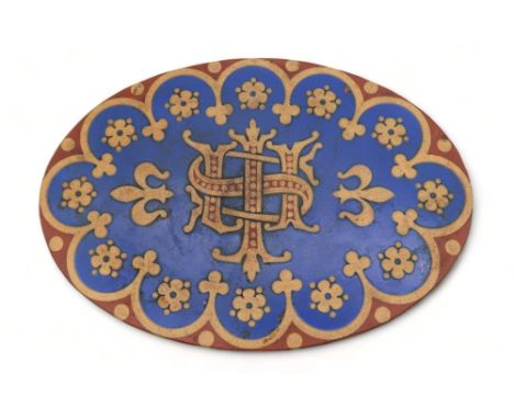 A Minton encaustic tile of oval shape with central initials surrounded by flowers and arched decoration Condition Report:Avai