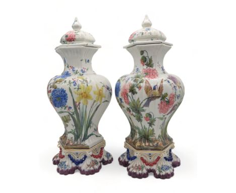 A pair of Le Nove faience glazed jars and covers on stands, painted with flowers and birds Condition Report:Available upon re