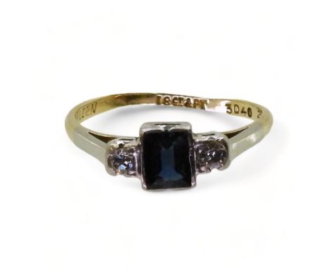 An 18ct and platinum sapphire and diamond ring set with a square cut sapphire of approx 5mm x 4mm x 2.2mm, and two diamonds w