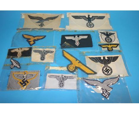 A Luftwaffe Officer's cape eagle, Army General's eagle, SS eagle emblem, a Flying Man emblem, Naval Officer's breast eagle, P