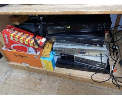 A shelf of assorted electrical goods, including DVD players, TV aerial and other items