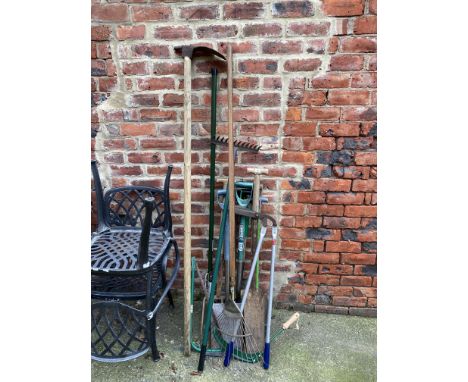 A bundle of assorted garden tools, including shovels, loppers and edging shears
