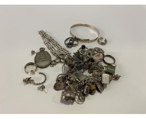 A sterling silver engraved bangle and a selection of other silver and white metal jewellery, including a filigree flower head