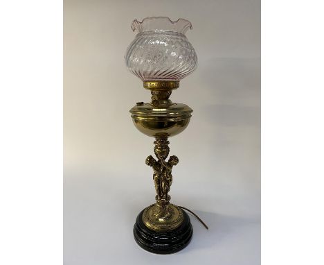 A 19th century brass oil lamp with pink glass shade, fitted for electricity, H 65cm