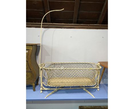 A white painted Victorian metal cot, with animal paw feet, measuring H 125cm