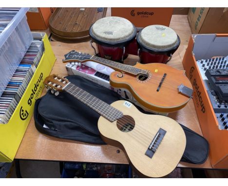 A pair of Remo bongos, a Guitalele GL1 and a Pilgrim by Vintage ukulele
