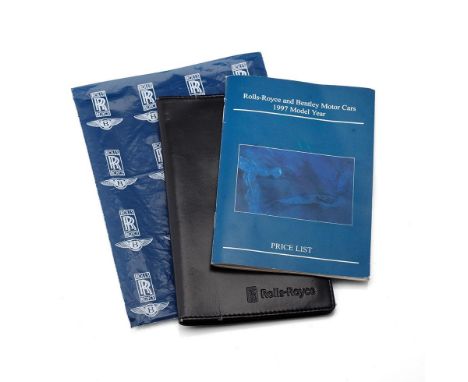 A 'Rolls-Royce and Bentley Motor Cars' 1997 Model Year, Price List, black leather Rolls-Royce wallet and RR plastic bag. (3) 