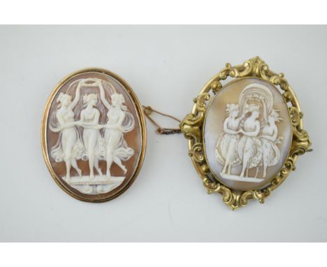 A pair of vintage cameo brooches, both depicting the three graces, metal frames (2), 6cm tall.  