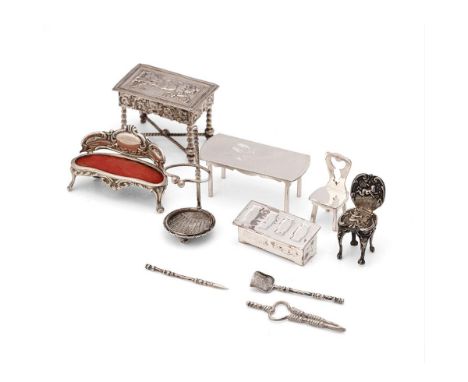 A collection of miniature silver furniture to include a grand sofa, Birm 1902, a .930 silver heavily embossed table with stre