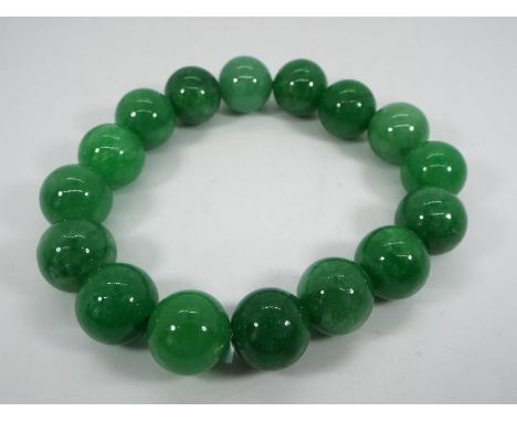 A 243.50 ct Burmese Green Jade stretchable bracelet issued in a limited edition 1 of 300, size of each stone 12 mm x 12 mm, w