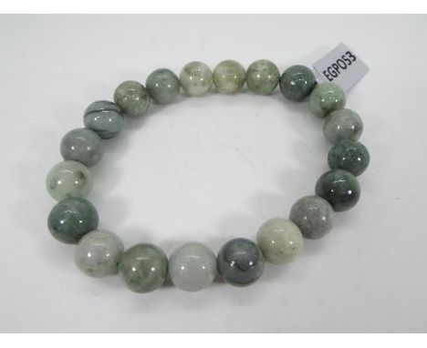 A 155.50 ct Moss-in-Snow Burmese Jade elastic bracelet issued in a limited edition 1 of 300, size of each stone 10 mm x 10 mm