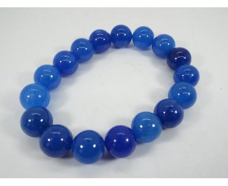 A 237 ct Burmese Blue Jade stretchable bracelet issued in a limited edition 1 of 300, size of each stone 11.5 mm x 11.5 mm, w