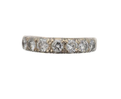 A diamond band ring by Boodle & Dunthorne. Set with seven brilliant cut diamonds in shared claw settings, estimated total dia