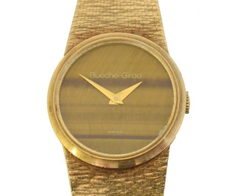 A 1970s 9ct gold Bueche Girod manual wind wristwatch. The signed circular tiger's eye dial with tapered hands, signed cal. 25