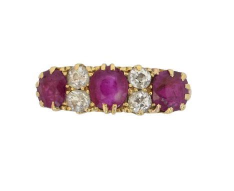 An early 20th century 18ct gold ruby and diamond dress ring. The cushion shape ruby line with old cut diamond spacers, hallma