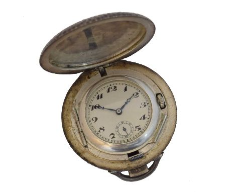 A 1920s silver travel clock/pocket watch by Marvin. Within a planished silver case, opening to reveal a white dial with Arabi