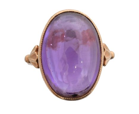 A 14ct gold amethyst single stone ring. The oval amethyst cabochon with tapered shoulders, USSR assay marks, ring size O1/2, 
