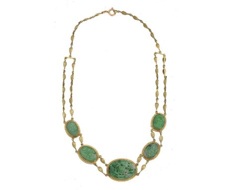 A jade necklace. Comprising five floral jade panels within textured settings, and fancy leaf link chain spacers, necklace sta
