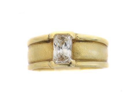 A diamond single stone ring.  The Barion cut diamond weighing approx. 0.80ct within a partial rub-over setting, to the textur