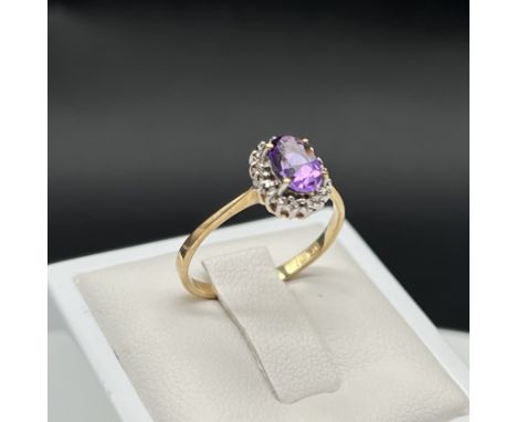 A 9ct yellow gold amethyst + diamond dress ring,
1.6 grams in weight approx,
fully hallmarked,
size P,
in good all round cond