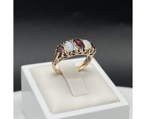 A 9ct yellow gold opal and garnet vintage ring, 3.2 grams in weight approx, size K