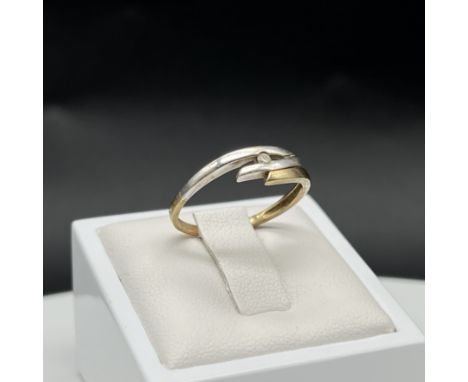 A 9ct yellow and white gold diamond twist ring, size P, 1.8 grams in weight approx, 