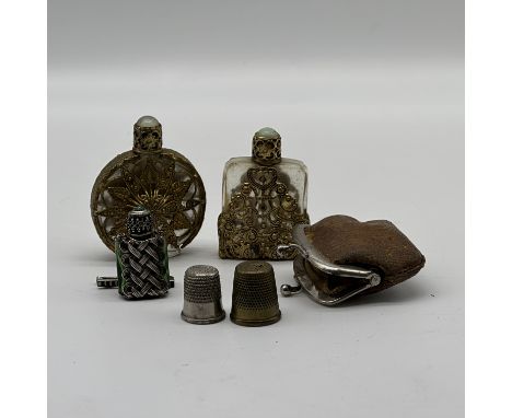 A collection of vintage perfume bottles and a small purse
