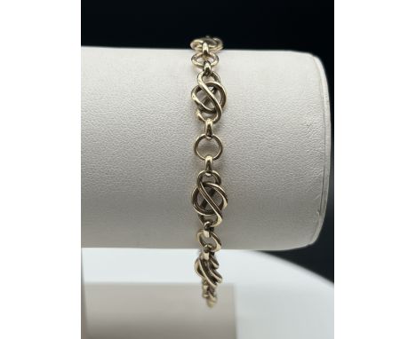 A 9ct yellow gold solid linked celtic bracelet,
fitted with safety chain,
11.6 grams in weigth approx,
7 inches long,
solid l