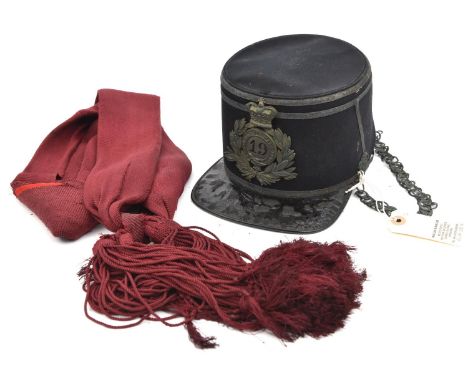 An officer's 1869 pattern shako of The 19th (1st York N Riding) Regt,  with shako plate, chinchain and ear rosettes (all tarn