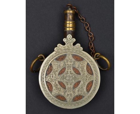 A Moroccan powder flask of cylindrical form. 20th century, 16.5cms made from copper, brass and nickel, and engraved with foli