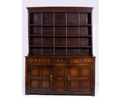 Joined oak dresser, circa 1800, three shelf delft rack with iron hooks to frieze, base with two lank top, fitted with three d