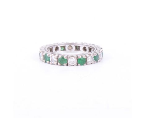 An emerald and diamond full eternity ring, ten emeralds and ten diamonds, brilliant cut stones, set in a white metal, overall