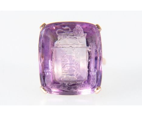 An amethyst intaglio seal ring, the rectangular carved amethyst 20mm x 17mm depicts a shield of three lion passant with lion 