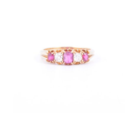 A ruby and diamond five stone ring, three rectangular rubies and two old cut diamonds claw set in an all yellow metal half ho