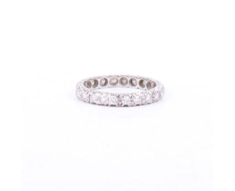 A diamond full eternity ring, twenty two brilliant cut diamonds claw set in a white metal mount, overall width 3mm. ring size