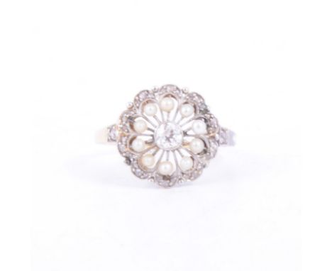 A pearl and diamond circular cluster ring, a central old cut diamond collet set and surrounded by a halo of ten 1.5mm pearls 