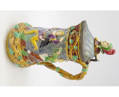Victorian Minton Majolica 'Tower' flagon, with Jester finial, the body relief moulded with mediaeval dancing figures & hinged