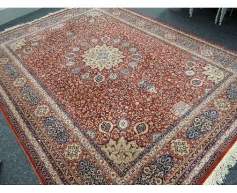 A GOOD KESHAN WOOL PILE floral rust ground and blue carpet, approximately 365cmsx277cms