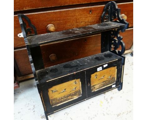 AN EBONISED AND GILT HANGING WALL SHELF AND CUPBOARD with Oriental decorated panels