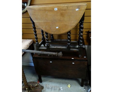A VINTAGE DROP-LEAF TABLE in light oak having barley-twist gate legs and another