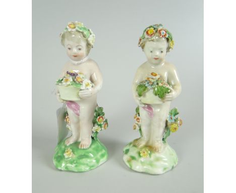 A PAIR OF DERBY PORCELAIN FIGURES modelled as putti with baskets of flowers, 10cms highNote: this lot is part of a collection