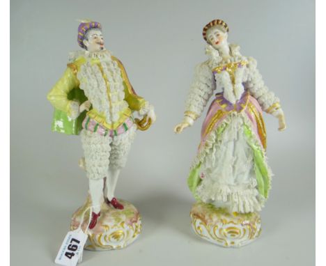 PAIR OF CONTINENTAL PORCELAIN LACEWORK FIGURES in the form of an elegantly dressed aristocrat male with dress sword and his p