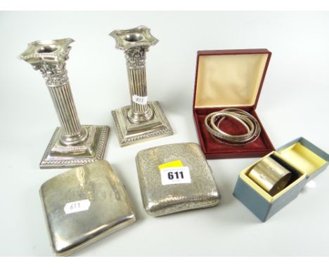 A PARCEL OF SILVER comprising pair of architectural square based candlestick holders, two concave silver cigarette cases, one