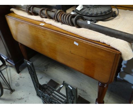 LIGHT OAK PEMBROKE TABLE with single drawer on turned legs with brass castors