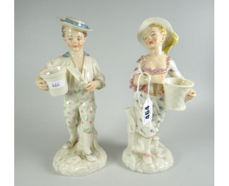 A PAIR OF ROYAL WORCESTER FIGURES believed by JAMES HADLEY in the form of a gardening boy holding plants, pot and trowel and 
