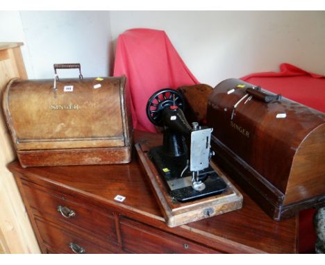 A COLLECTION OF THREE VINTAGE CASED SINGER SEWING MACHINES