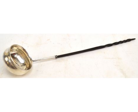 A Georgian white metal toddy ladle with whale bone handle, the circular bowl set with George III coin, length 30cm (af).