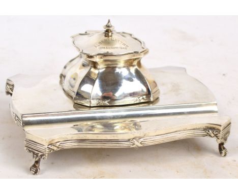 An early 20th century hallmarked silver ink standish, the central lidded well inscribed "Albert Cattan 19th August 1945", abo
