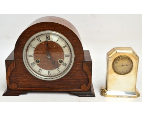 A George V hallmarked silver mantel timepiece of canted rectangular form, raised on a small plinth with eight day Swiss movem