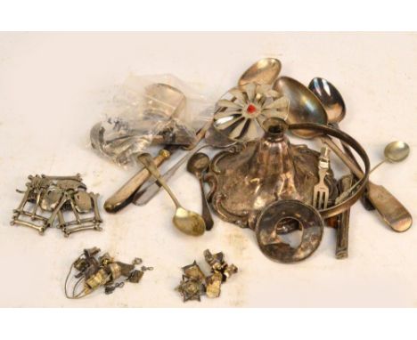 A quantity of white metal items including spoons, a candlestick base, etc.